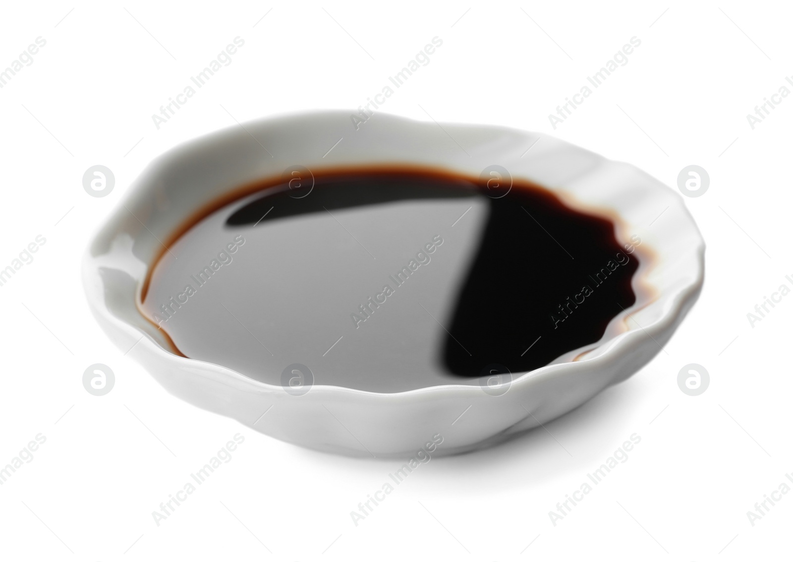 Photo of Bowl of soy sauce on white background