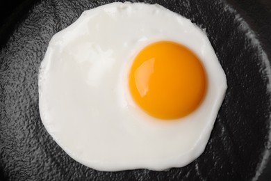 Tasty fried egg in pan, top view