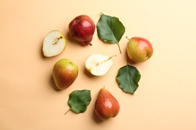 Ripe juicy pears on beige background, flat lay