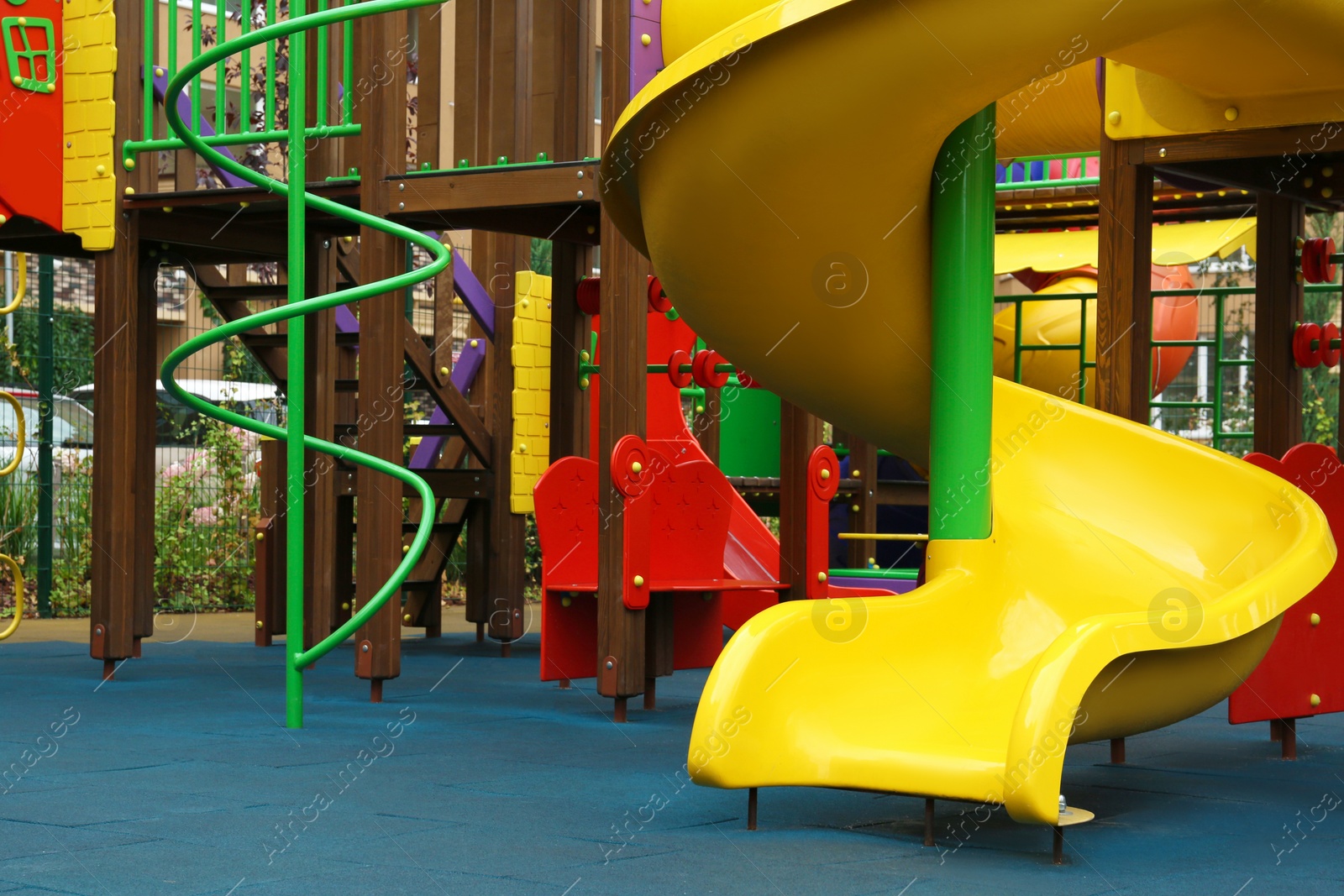 Photo of Colourful slide on outdoor playground for children in residential area