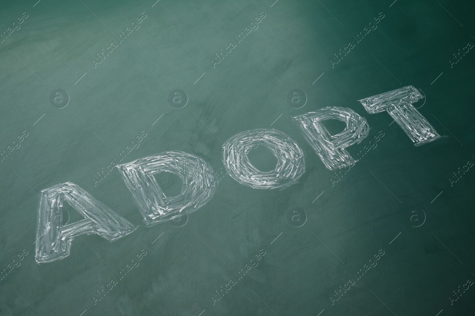 Photo of Word Adopt written with chalk on board