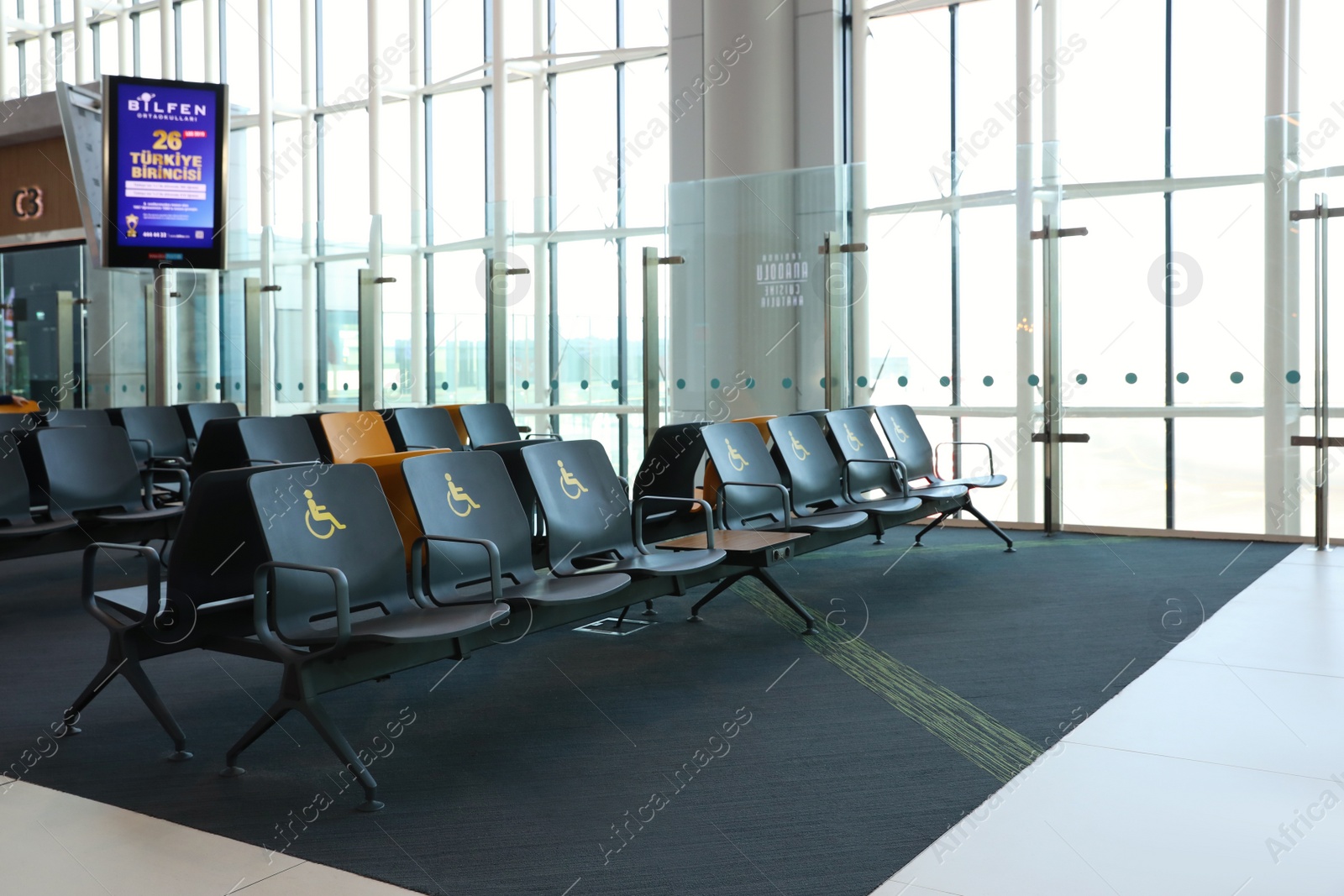 Photo of ISTANBUL, TURKEY - AUGUST 13, 2019: Waiting area with seats for handicapped people in new airport terminal