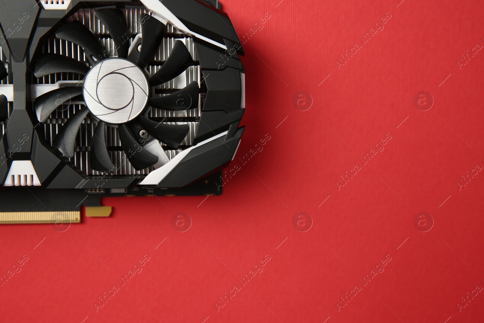 Photo of Computer graphics card on red background, top view. Space for text
