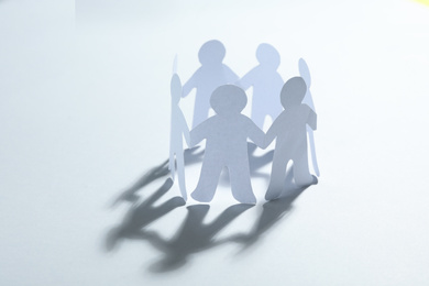 Paper people chain making circle on white background. Unity concept