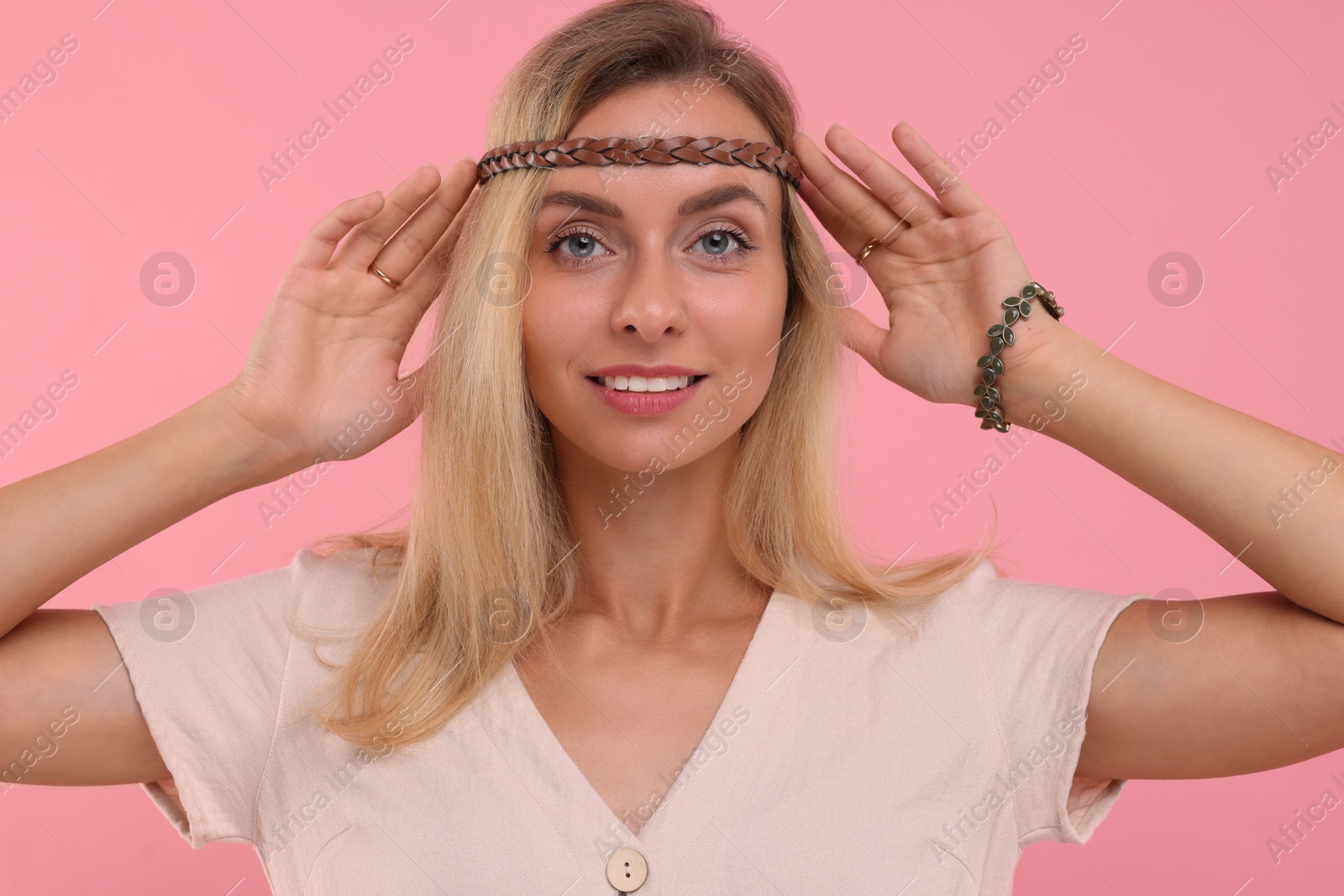 Photo of Portrait of beautiful hippie woman on pink background