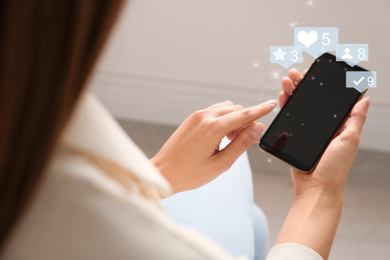 Young woman using modern smartphone indoors, closeup