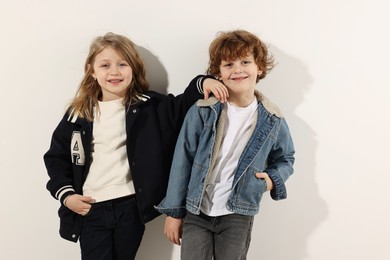 Photo of Fashion concept. Stylish children posing on white background