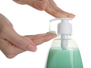 Woman using liquid soap dispenser on white background, closeup