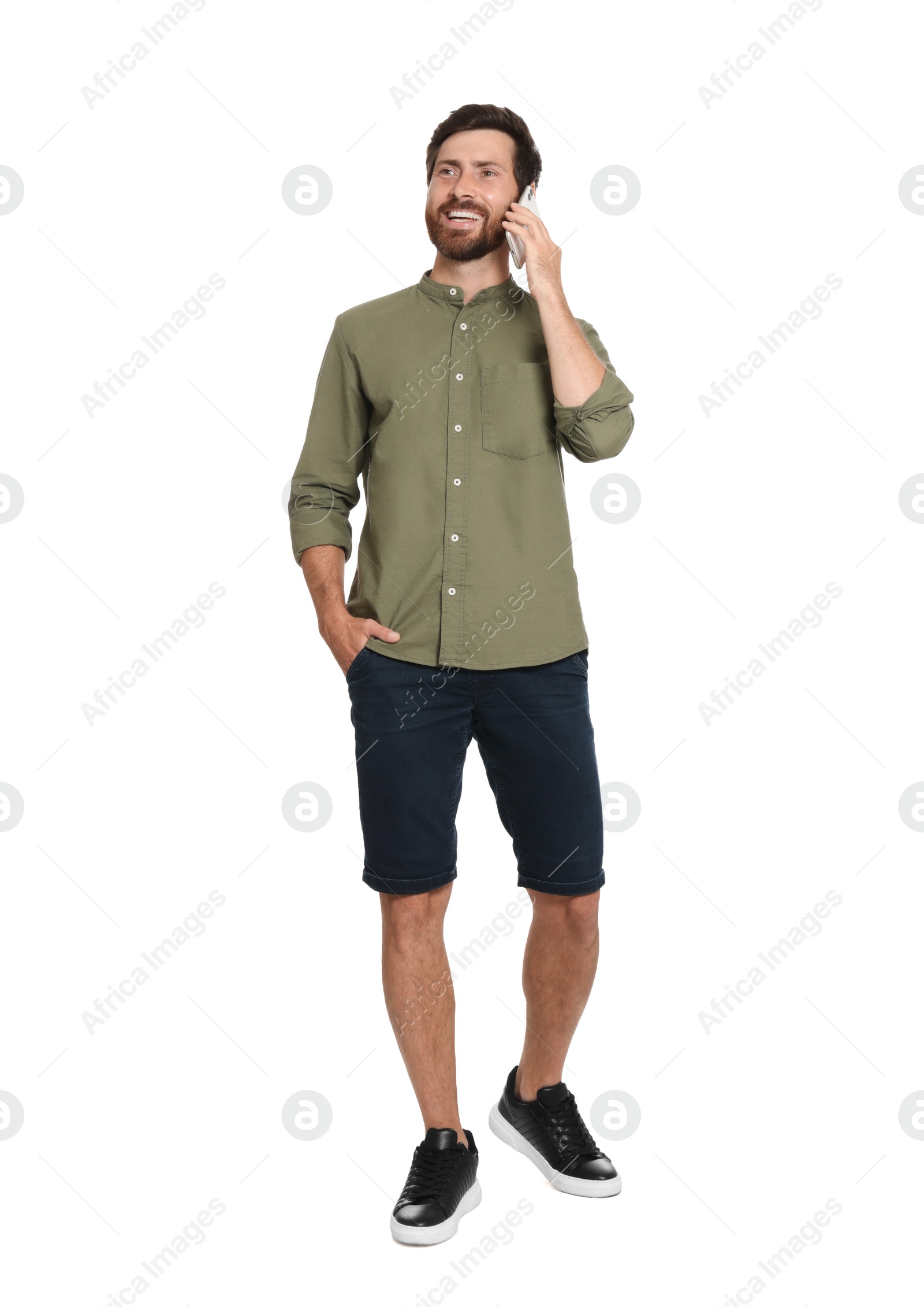 Photo of Handsome man talking on phone against white background