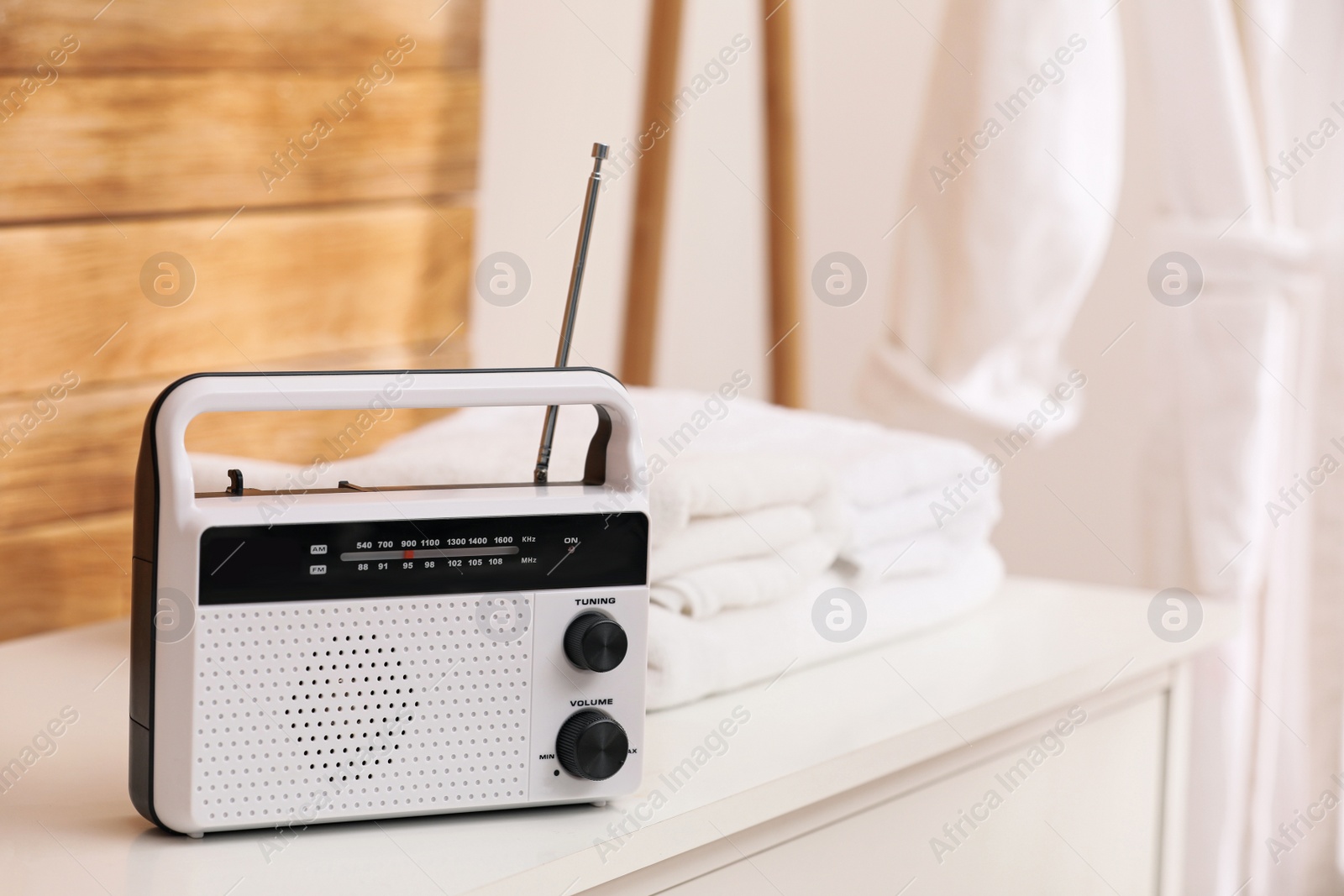 Photo of Stylish white radio on table in bathroom, space for text