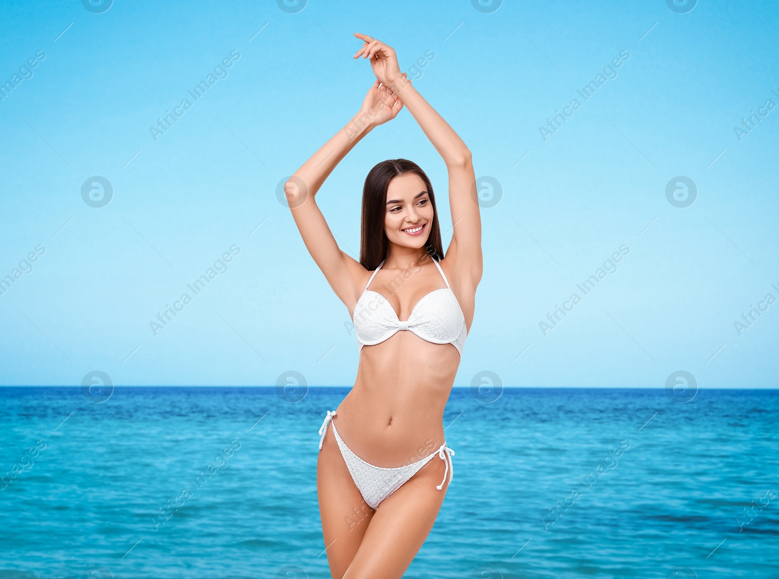 Image of Happy woman in stylish white bikini near sea