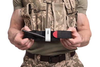 Soldier in military uniform holding medical tourniquet on white background, closeup