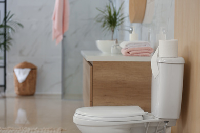 Interior of modern bathroom with toilet bowl