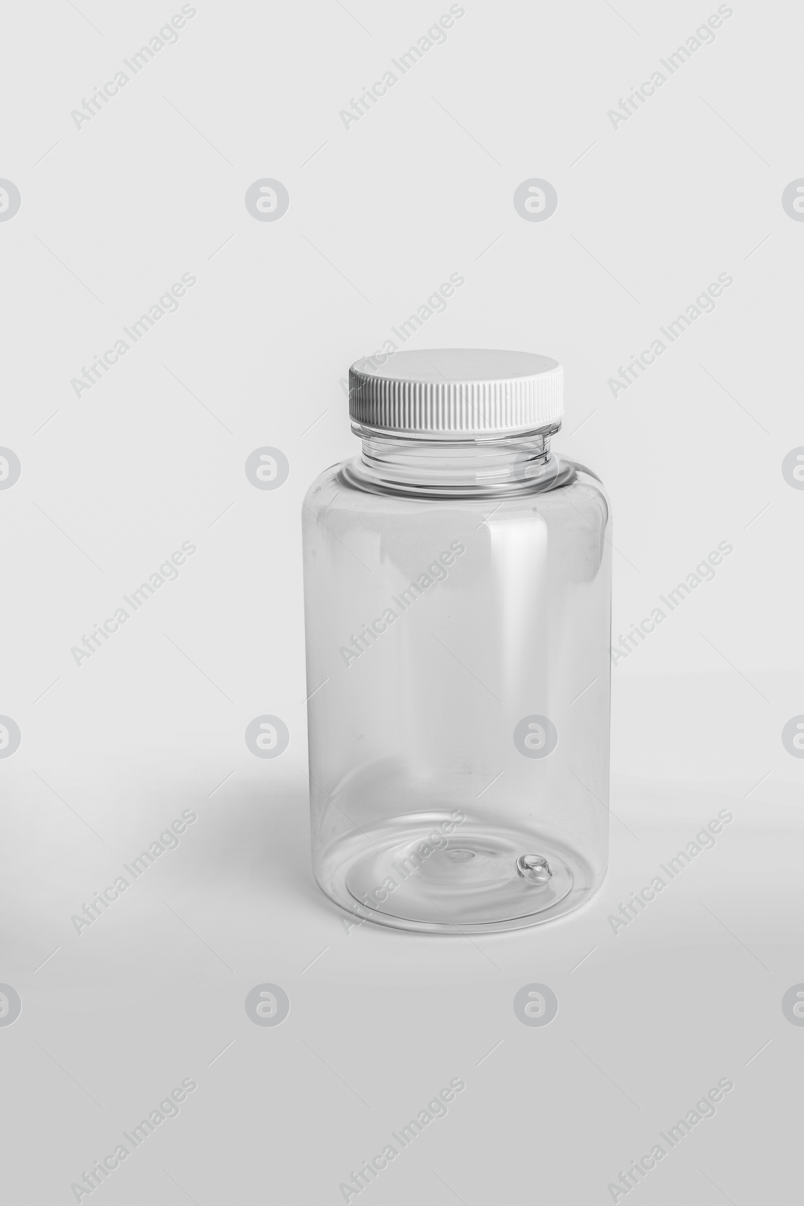 Photo of Empty transparent medicine bottle on white background