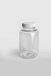 Photo of Empty transparent medicine bottle on white background