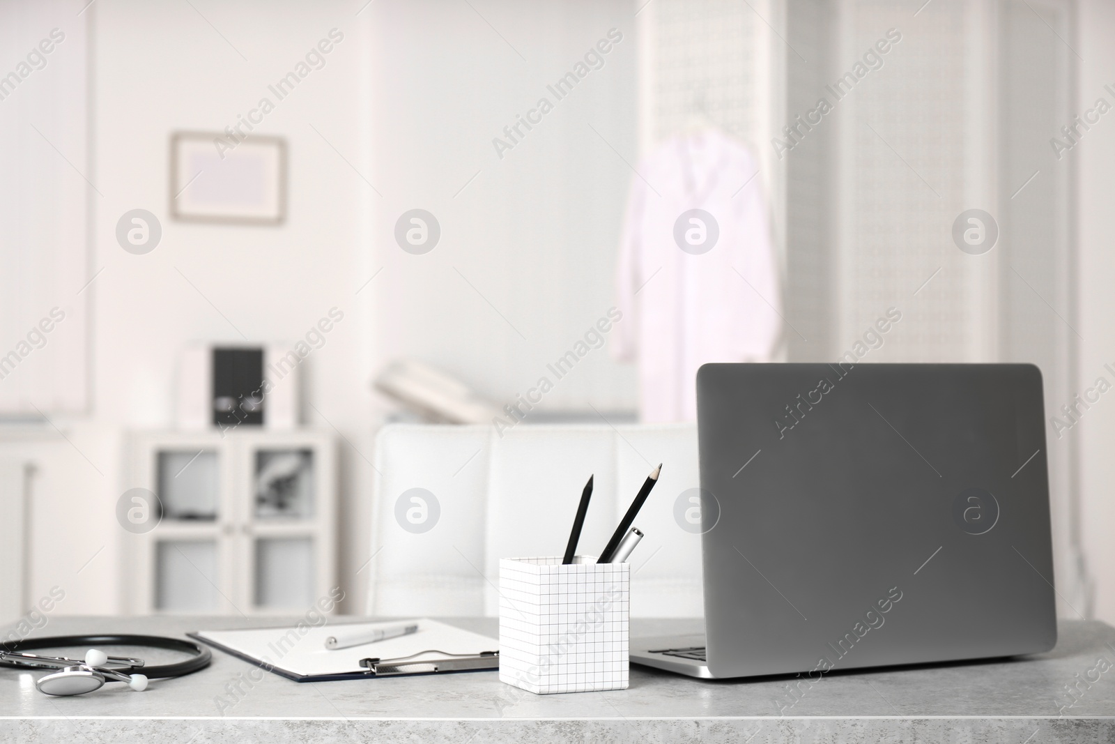 Photo of Doctor's workplace with laptop in modern clinic