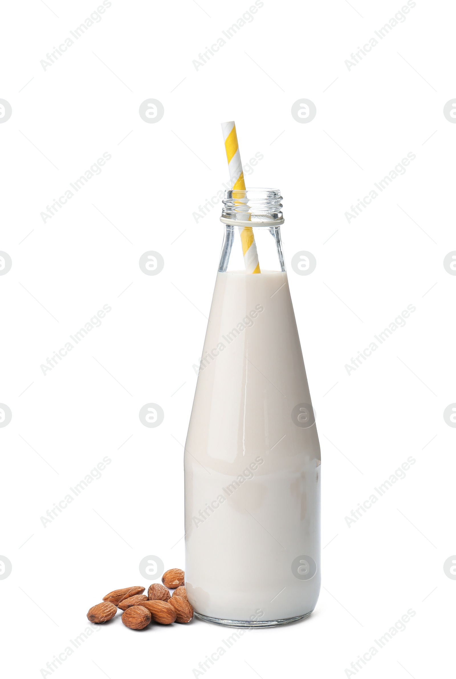Photo of Bottle with almond milk and nuts on white background
