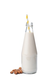 Bottle with almond milk and nuts on white background