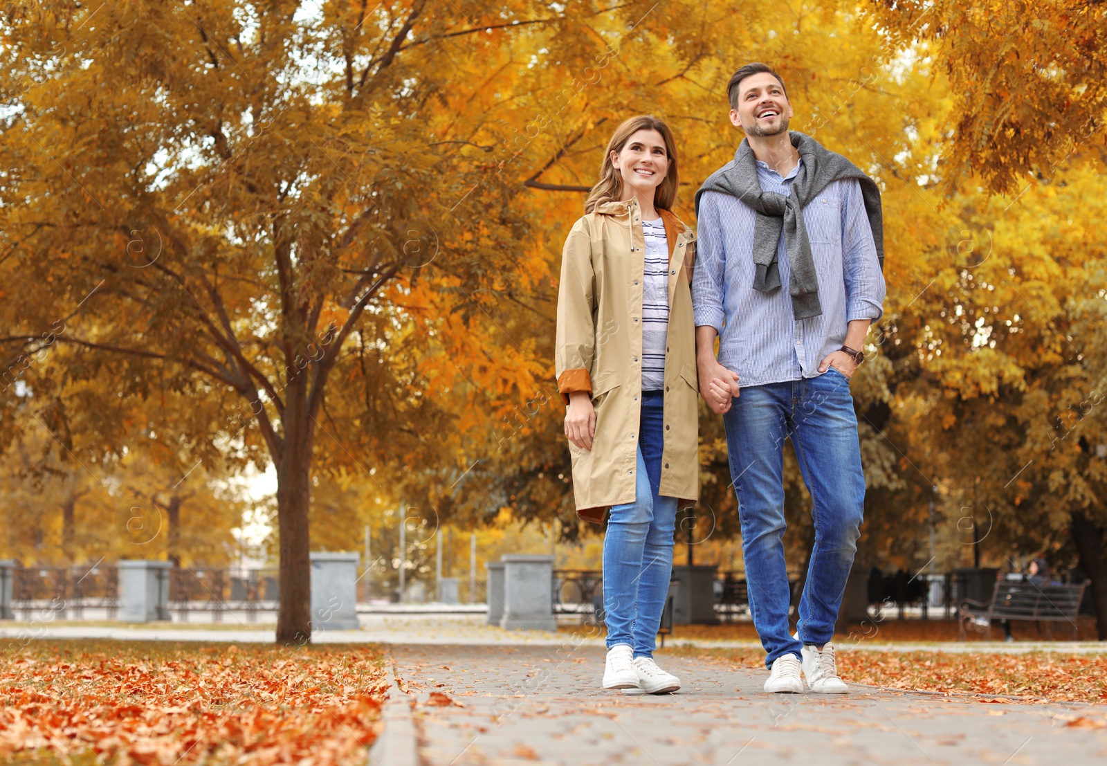 Photo of Lovely couple spending time together in park. Autumn walk