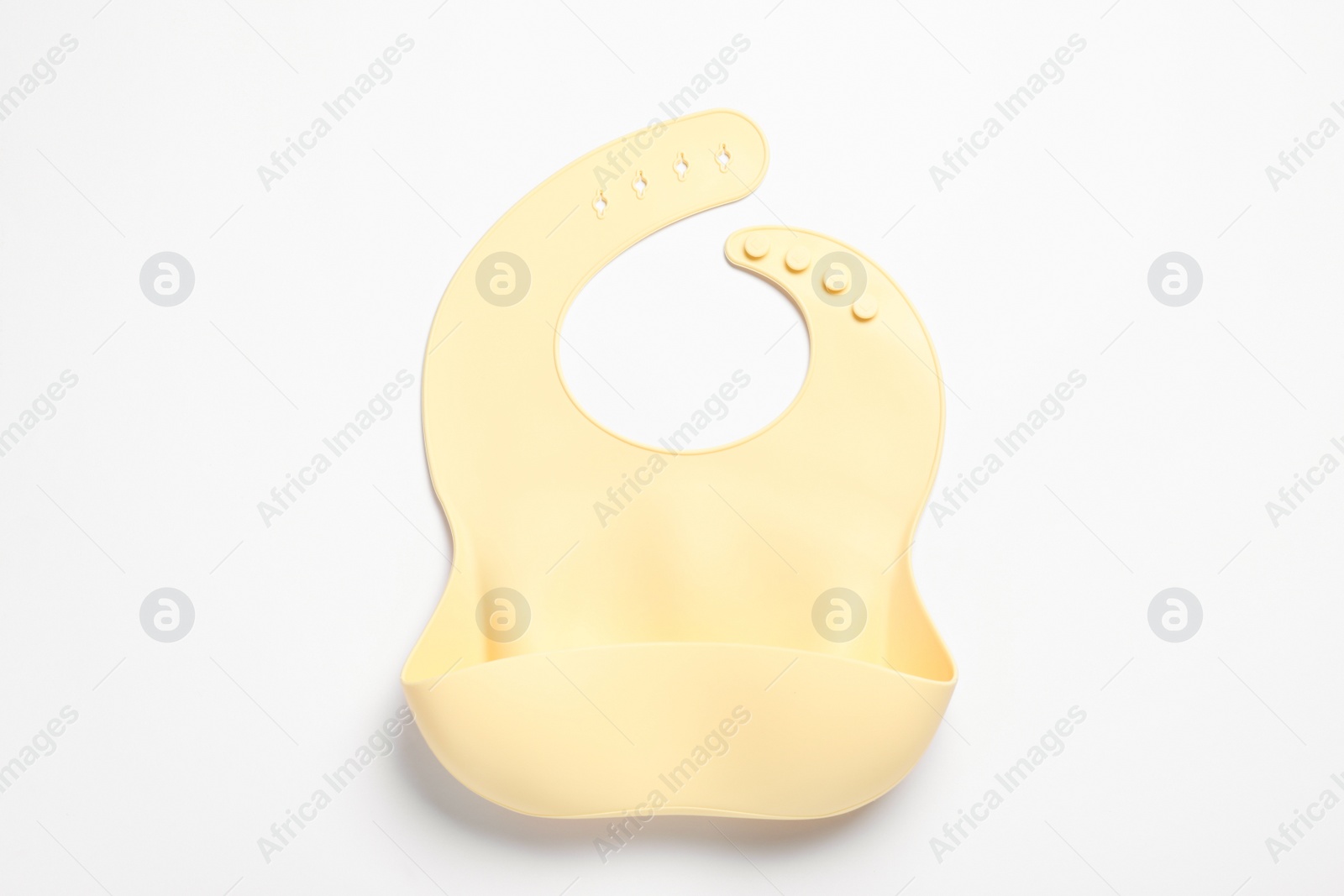 Photo of Beige silicone baby bib isolated on white, top view