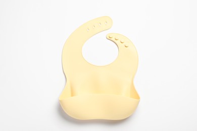 Photo of Beige silicone baby bib isolated on white, top view