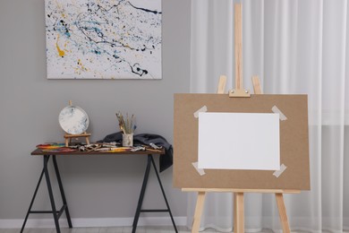 Wooden easel with taped paper in artist's studio