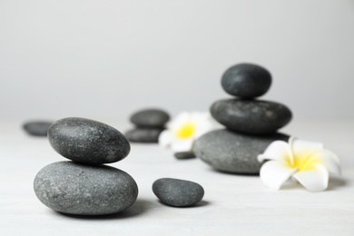 Photo of Composition with spa stones on table. Space for text