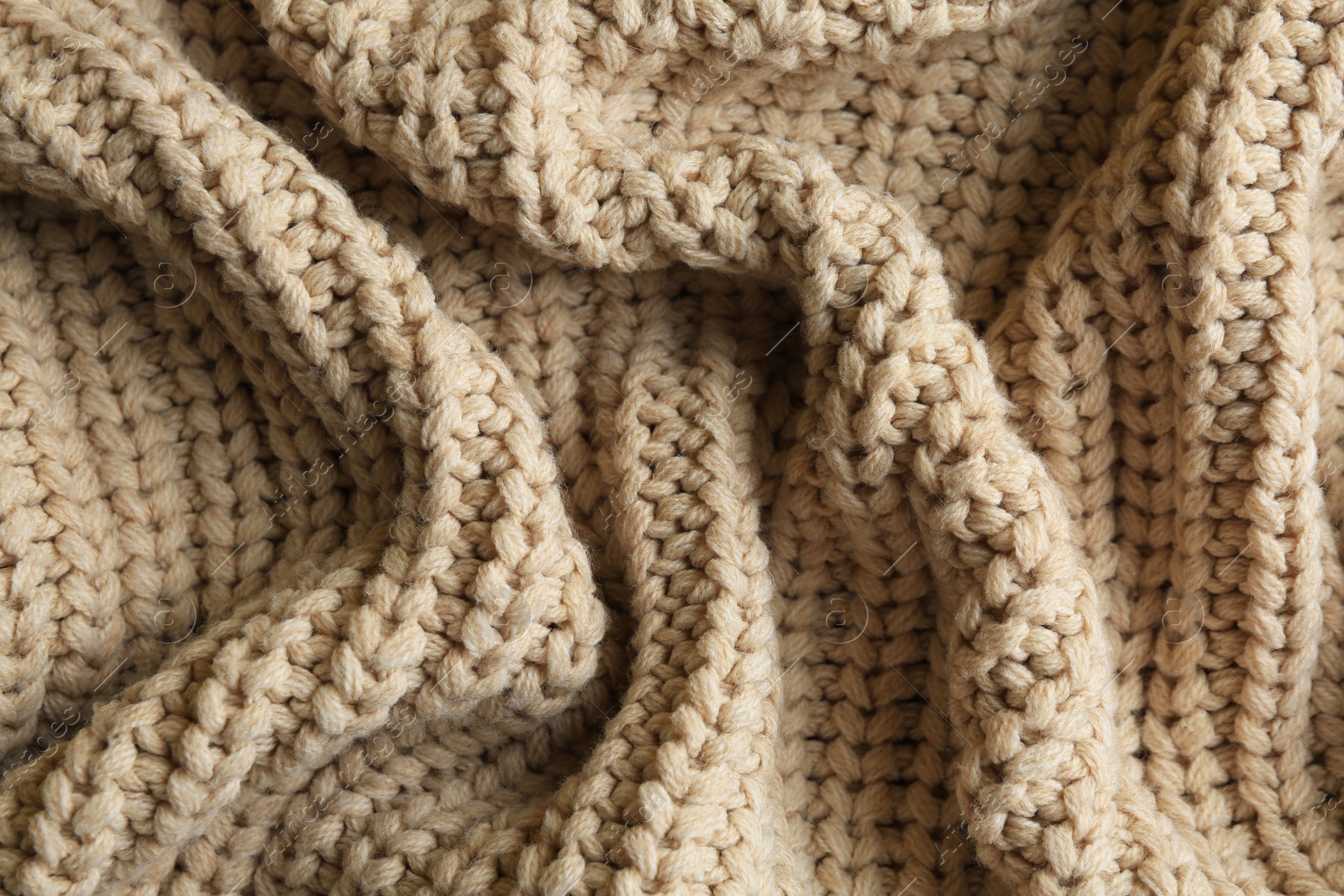 Photo of Beautiful beige knitted fabric as background, top view