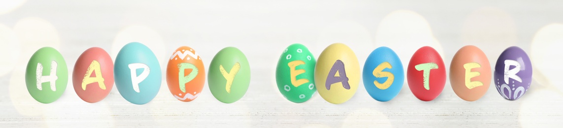 Image of Happy Easter. Colorful dyed eggs on light background, banner design