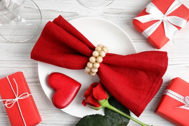 Photo of Beautiful place setting with decorative heart on white wooden table, flat lay. Valentine's day romantic dinner