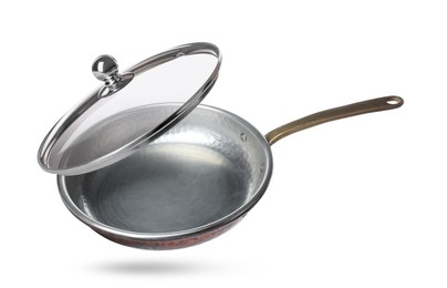 Image of New frying pan and glass lid on white background