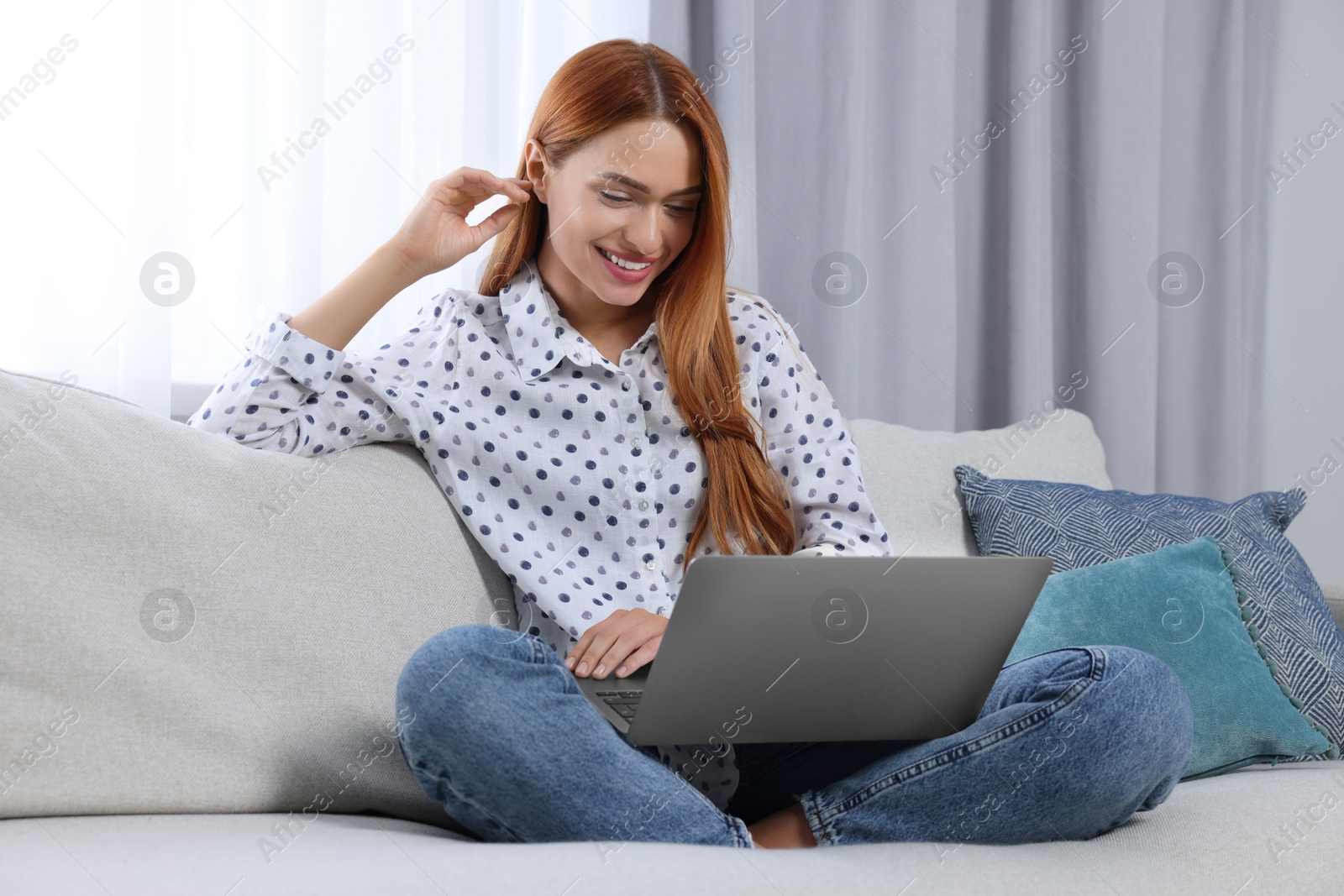 Photo of Woman having video chat via laptop at home