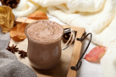 Cup of hot drink on white table. Cozy autumn atmosphere