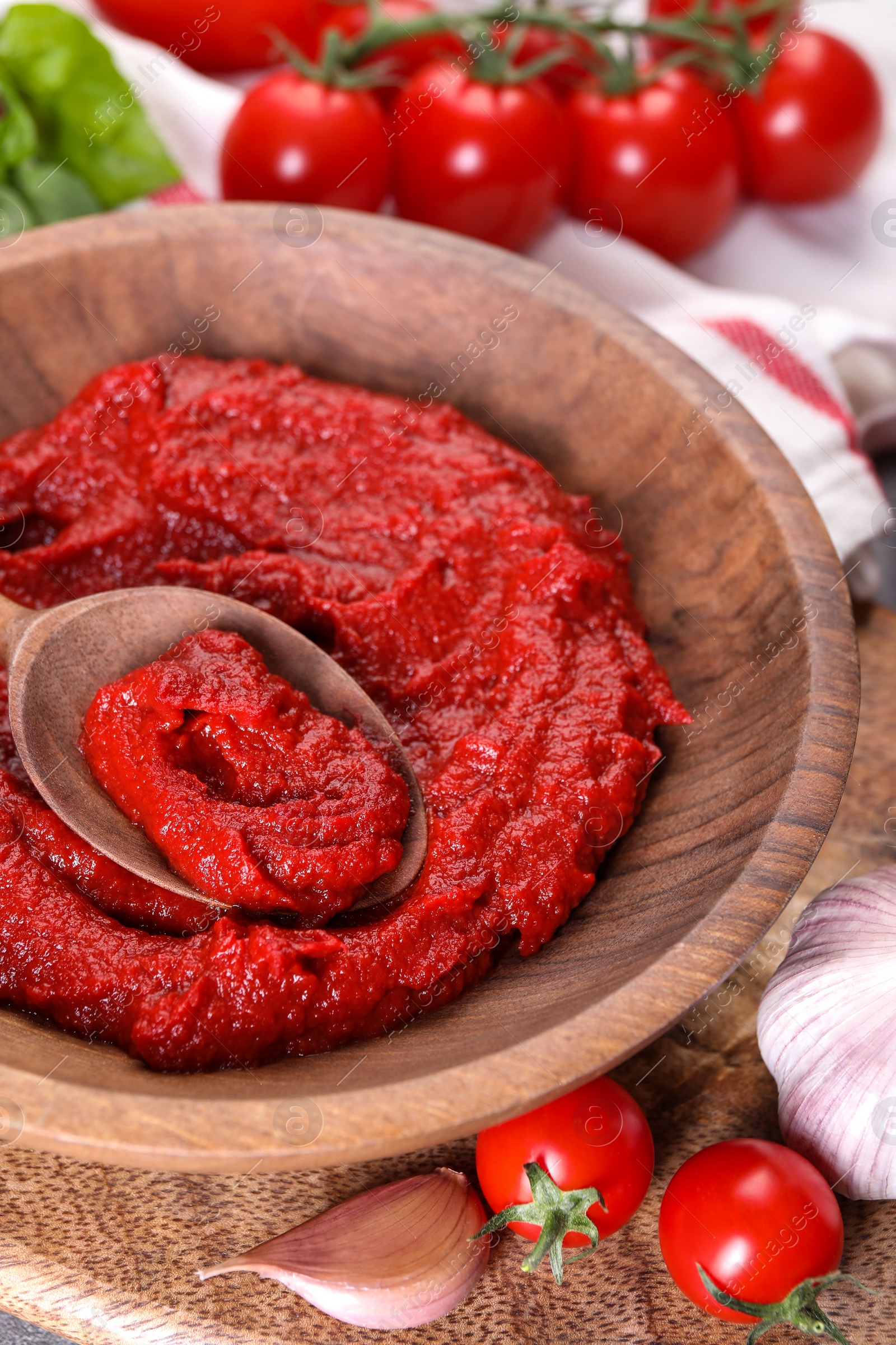 Photo of Tasty tomato paste and ingredients on table