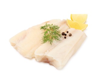 Pieces of raw cod fish, dill, peppercorns and lemon isolated on white