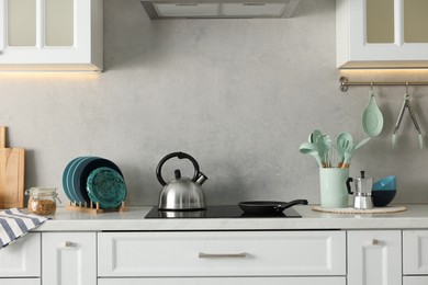 Set of different utensils and dishes on countertop in kitchen