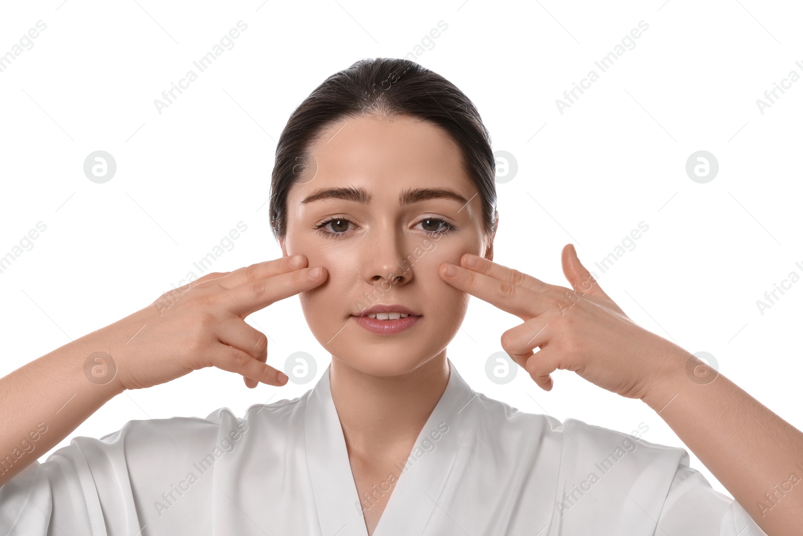 Photo of Young woman massaging her face on white background