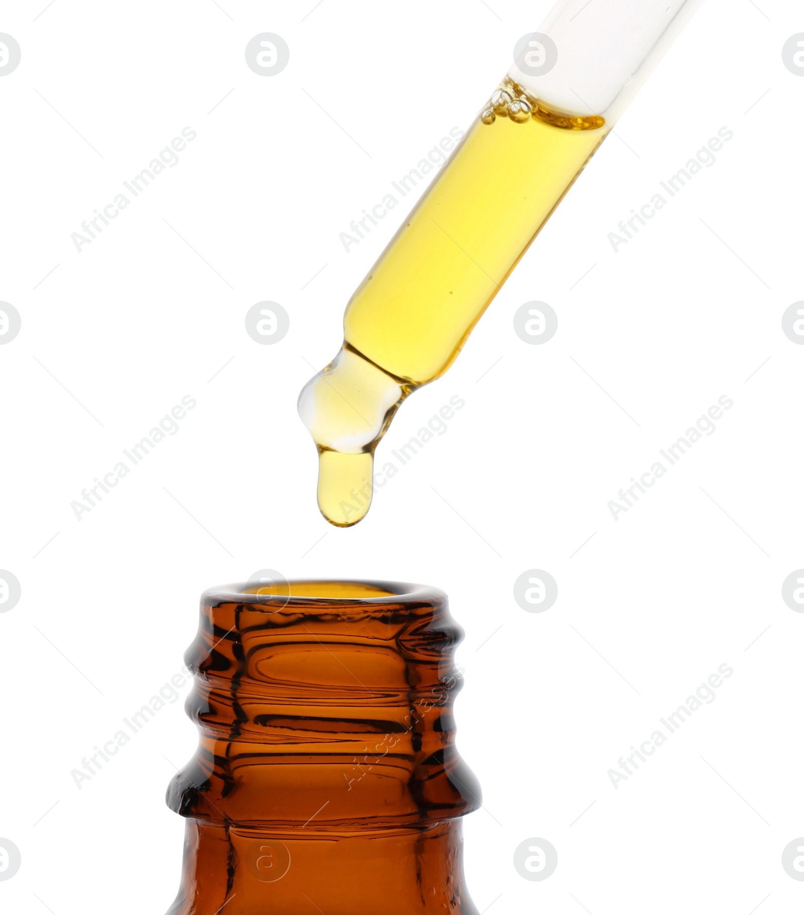 Photo of Dripping tincture from pipette into bottle isolated on white