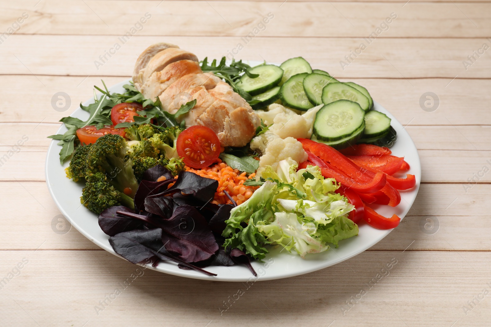 Photo of Balanced diet and healthy foods. Plate with different delicious products on wooden table