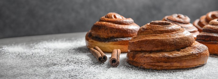 Image of Cinnamon rolls and sugar powder on table, space for text. Banner design