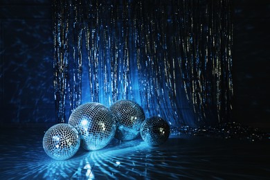 Photo of Shiny disco balls indoors, toned in dark blue