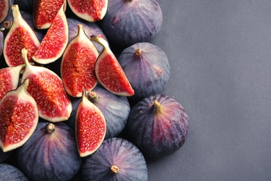 Photo of Fresh ripe figs on gray background, top view. Space for text