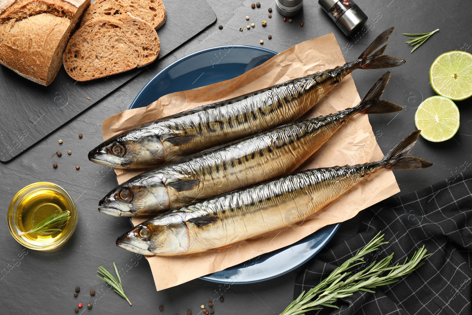 Photo of Flat lay composition with smoked fish on black table