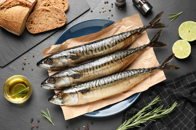 Flat lay composition with smoked fish on black table