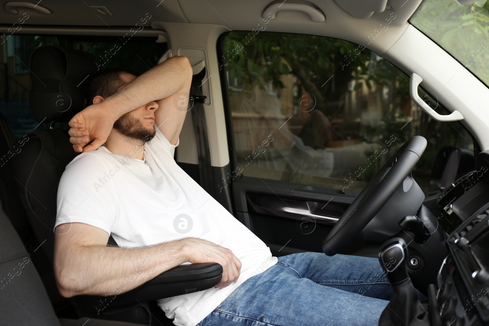 Photo of Tired man sleeping in his modern car