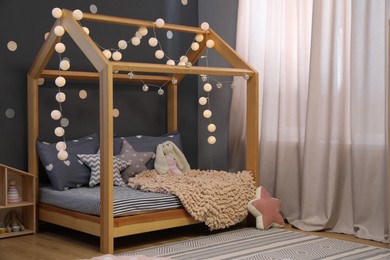 Photo of Stylish child room interior with comfortable bed