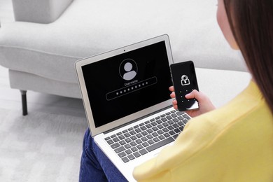 Woman unlocking smartphone with blocked screen near laptop indoors, closeup