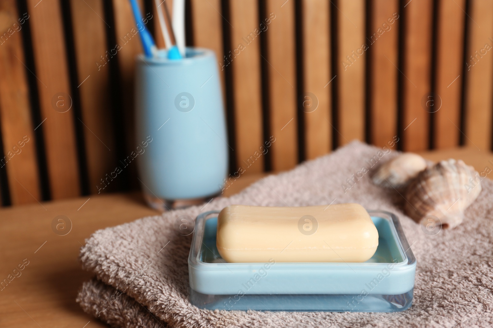 Photo of Dish with soap and towel on table. Space for text