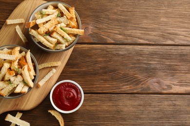 Photo of Delicious hard chucks with ketchup on wooden table, flat lay. Space for text