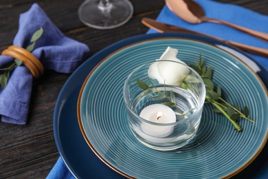 Photo of Elegant festive table setting on black wooden background, closeup